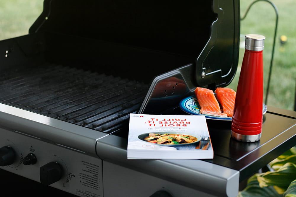 grill cookbook and water bottle with salmon